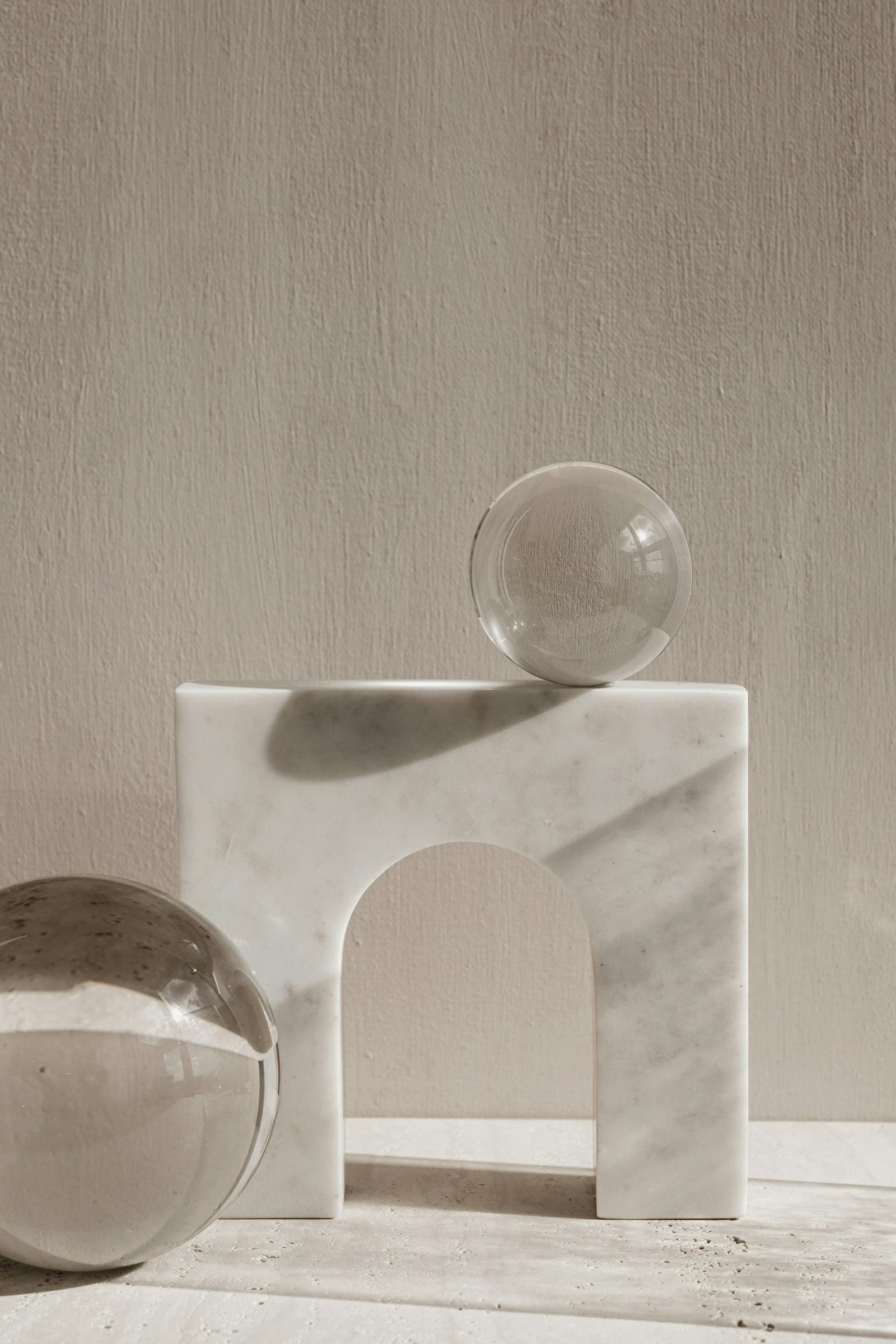 Marble arch and glass spheres in warm light